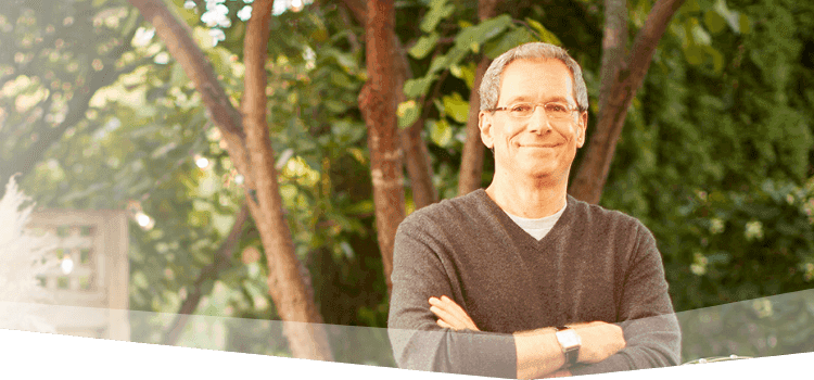 Banner photo at the top of the page showing a man looking confidently at the camera as he prepares for a backyard barbecue. 