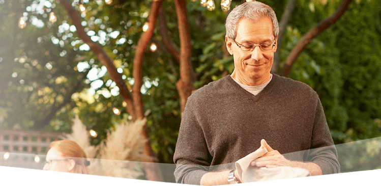 Banner photo at the top of the page showing a man preparing for a backyard barbecue.  